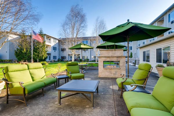 Comfortable outdoor seating with green chairs and umbrellas