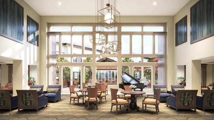 Spacious common area with seating and piano for residents