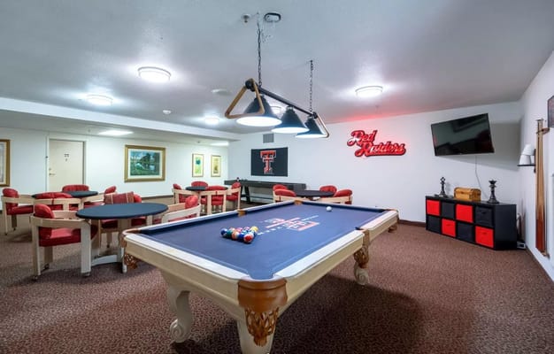 Interior of a billiards room with pool table and seating
