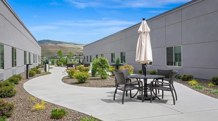 Outdoor seating area with a pathway and landscaping
