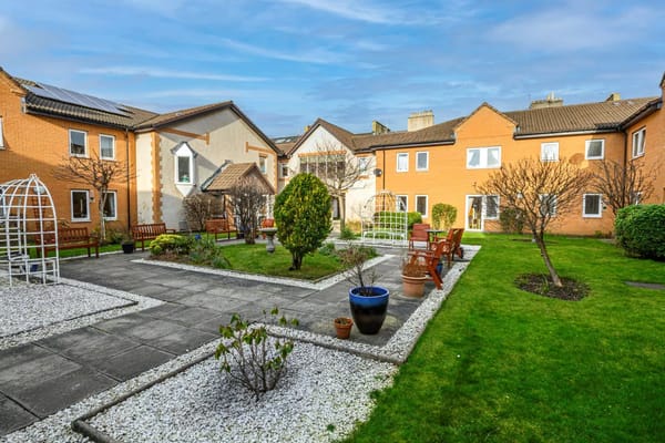 Well-maintained garden area with seating and pathways