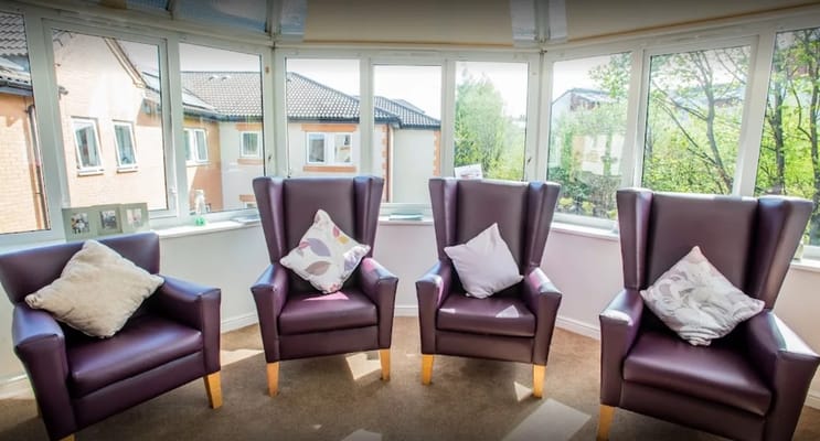 Cozy seating area with large windows in a common room