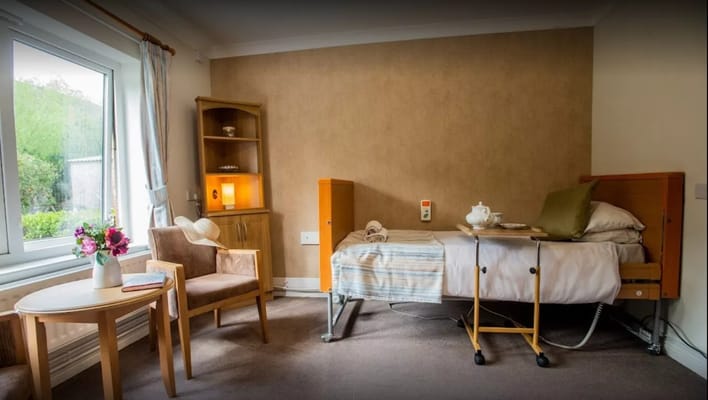 Cozy resident room with a bed and seating area