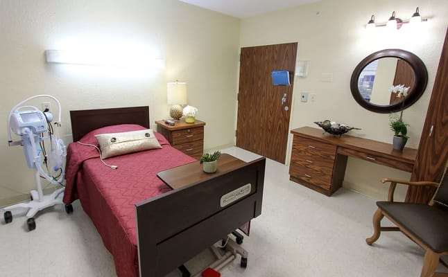 Well-furnished private resident room with a bed and decor