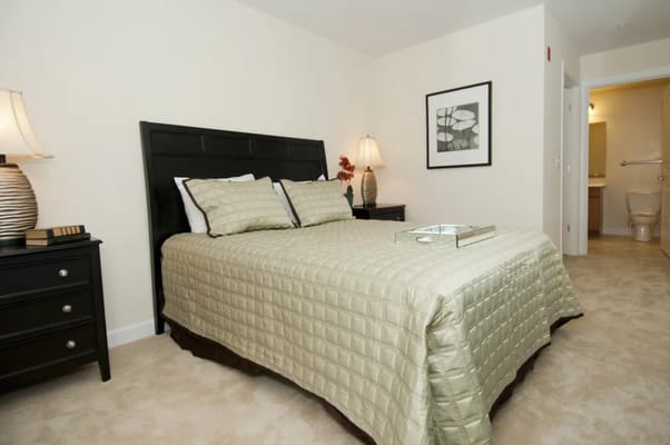 A well-decorated bedroom with a queen bed and bedside tables