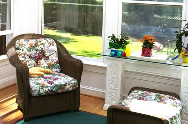 Cozy seating area with floral cushions and sunlight