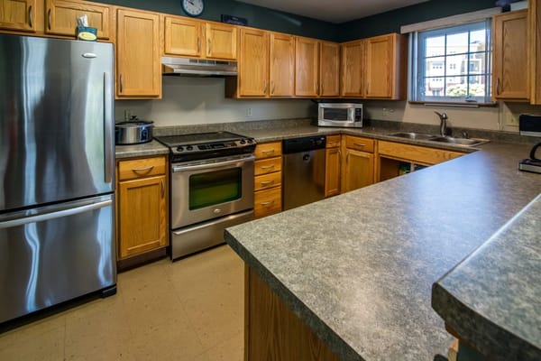 Modern kitchen with stainless steel appliances and wooden cabinets