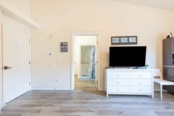 Interior of a resident's room with a TV and furniture
