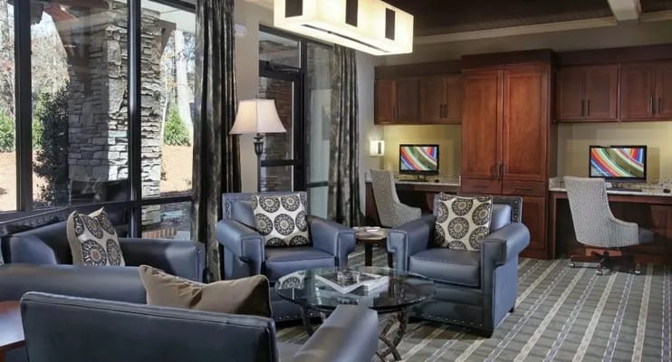 Comfortable seating area with computers in a well-lit lobby