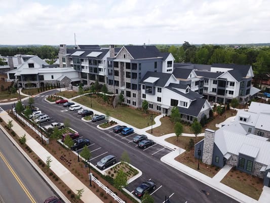 Aerial view of Village Park at Milton showing the exterior and parking area.