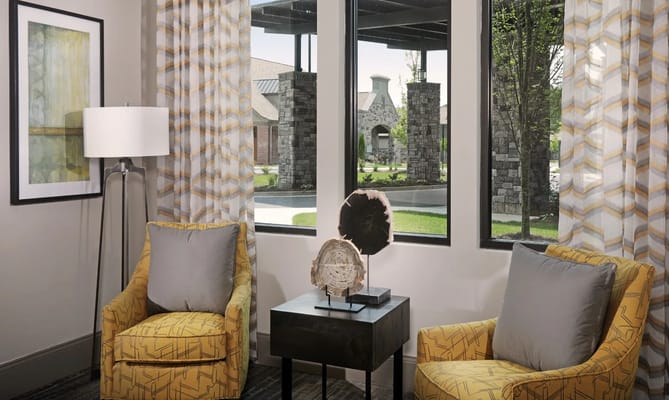 Cozy sitting area with yellow chairs and large windows