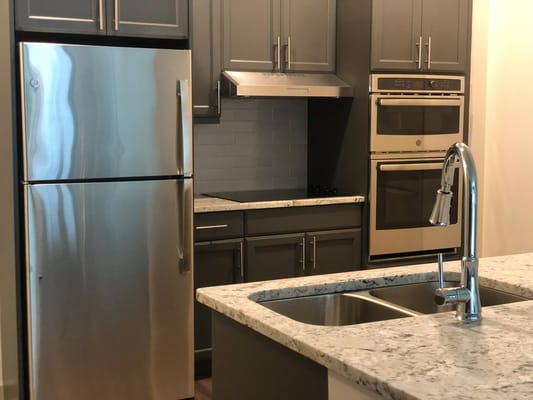 Stylish kitchen with stainless steel appliances and granite countertops