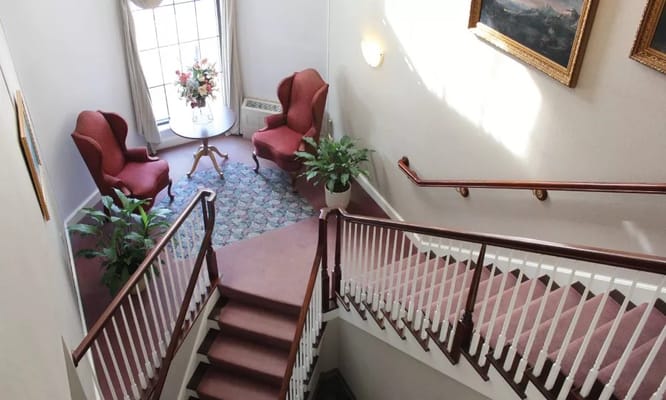 View of staircase leading to lobby with seating area