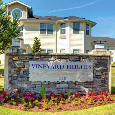 Exterior sign for Vineyard Heights Assisted Living with flowers