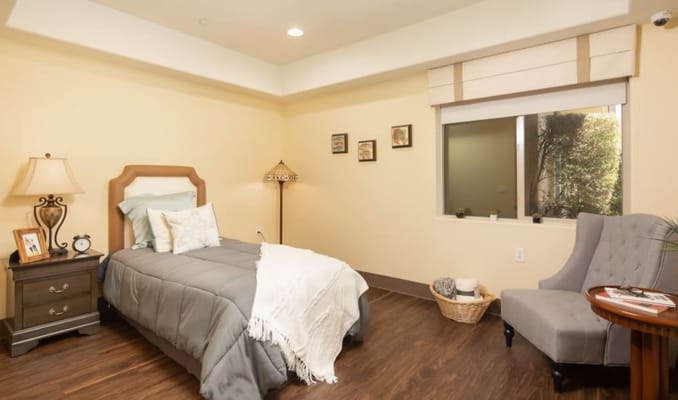 A well-furnished private room in a senior living facility