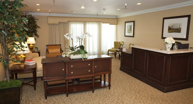 Spacious lobby area with seating, plants, and decorative elements.