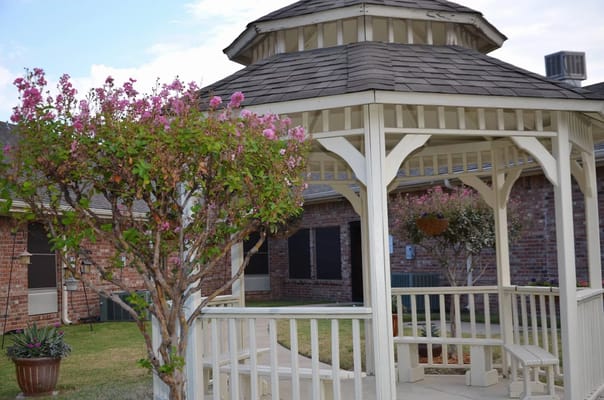Gazebo surrounded by blooming trees in outdoor space
