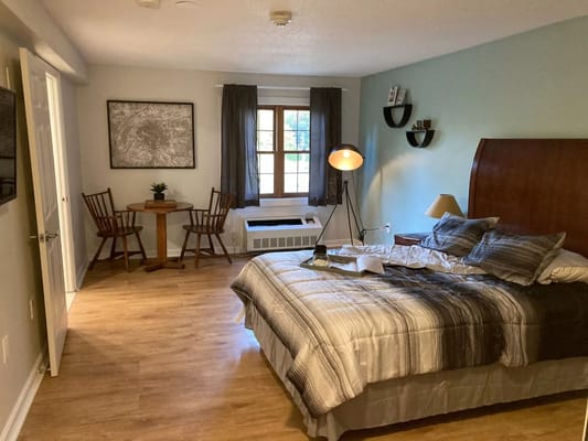 Cozy private room with a bed and seating area