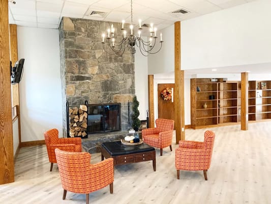 Interior common area with seating by a fireplace