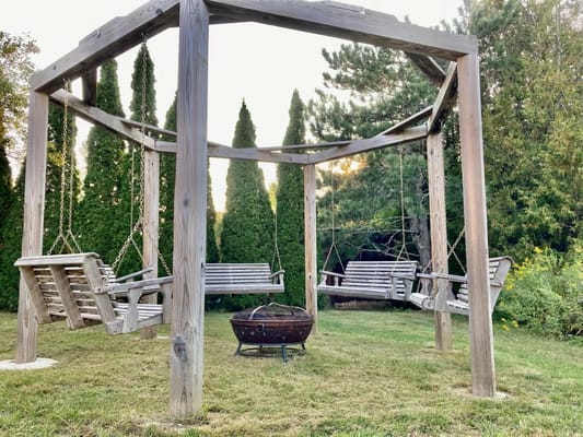 Outdoor swinging benches in a serene garden setting