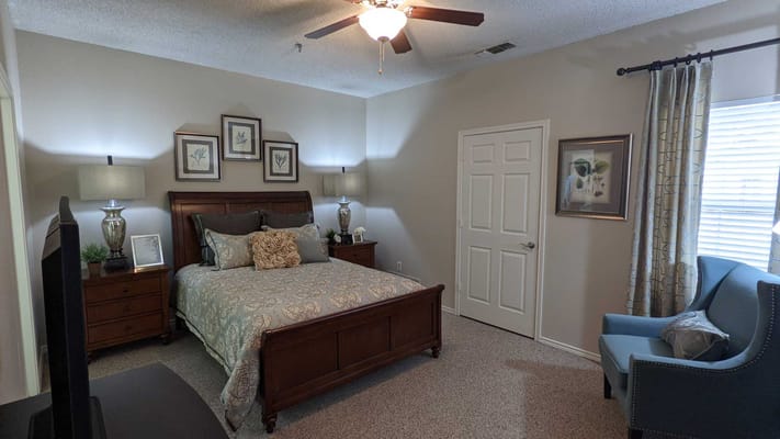 Cozy resident bedroom with a bed and seating area