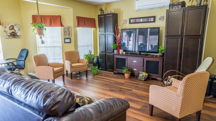 Common area with seating and plants in a senior living facility