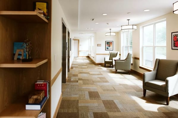 Brightly lit corridor with seating and decor