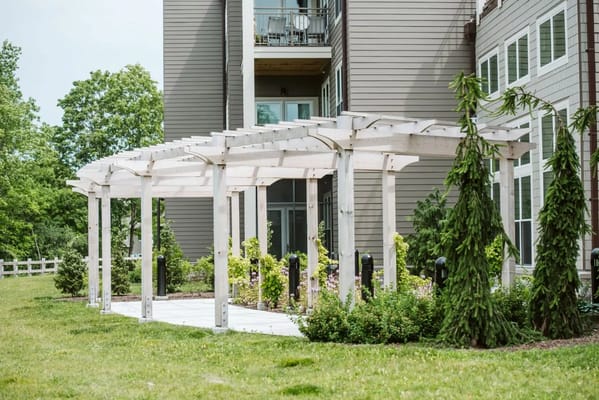 Outdoor pergola area with landscaping