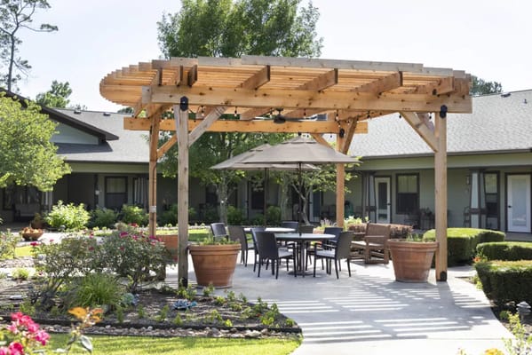 Outdoor seating area with pergola and garden