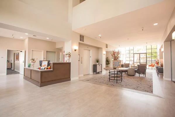 Bright and spacious lobby area with seating and reception desk