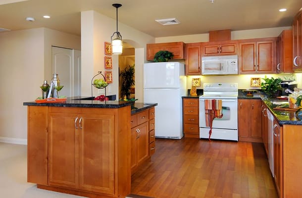 Bright and spacious kitchen with wooden cabinets and modern appliances