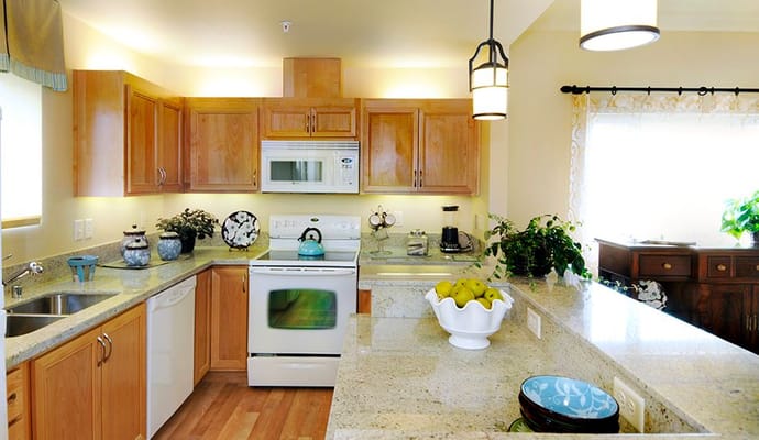 Bright kitchen with wooden cabinets and granite countertops