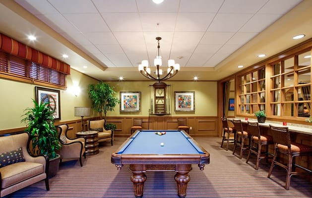 Interior view of the game room with a pool table and seating area.
