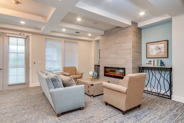 Bright interior common area with seating and fireplace