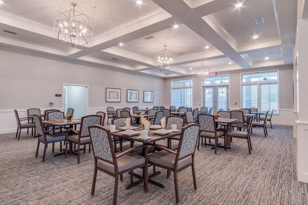 Dining room with elegantly set tables and chairs