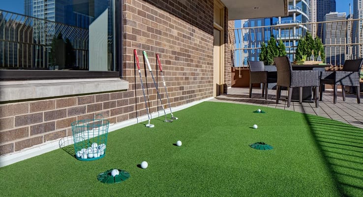Outdoor putting green with golf equipment