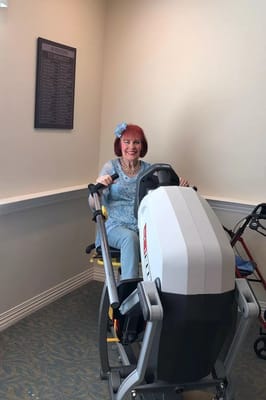 Senior resident exercising on gym equipment