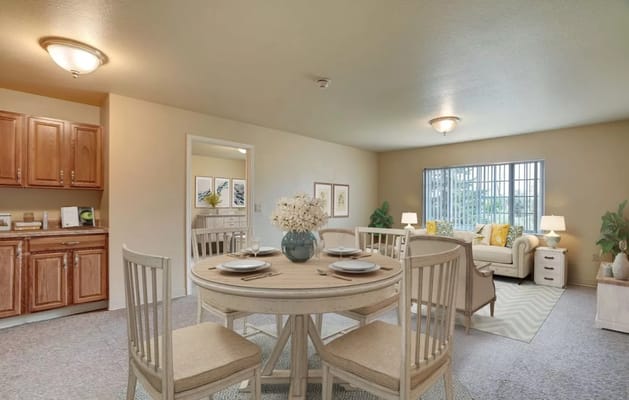 Bright dining area with a round table and comfy seating