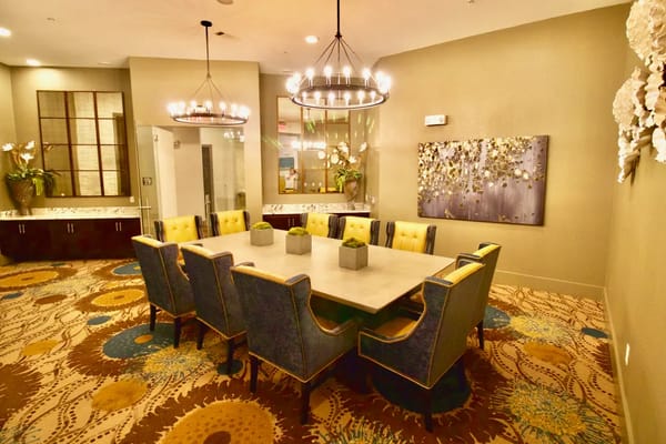 Elegant dining room with a large table and colorful chairs