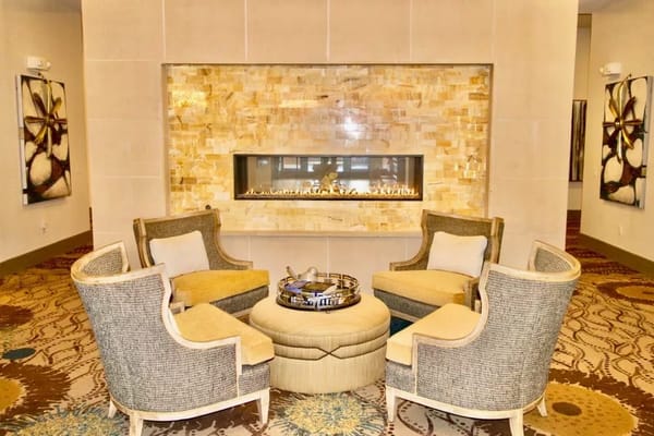 A cozy seating area around a modern fireplace