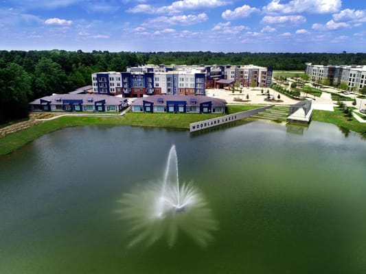 Aerial view of Watermere at Woodland Lakes with a fountain in the lake