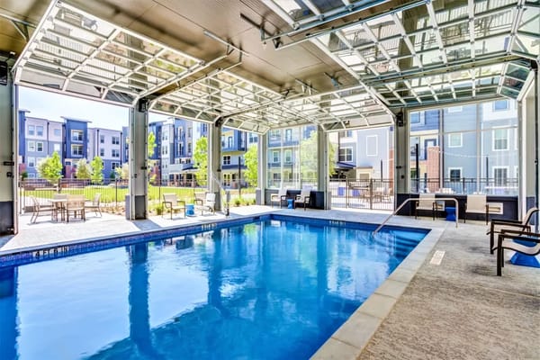 Bright indoor pool with large windows and seating area