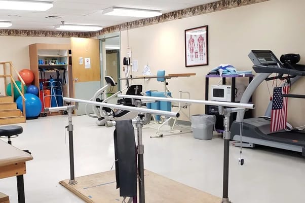 Interior view of a rehabilitation therapy room with equipment