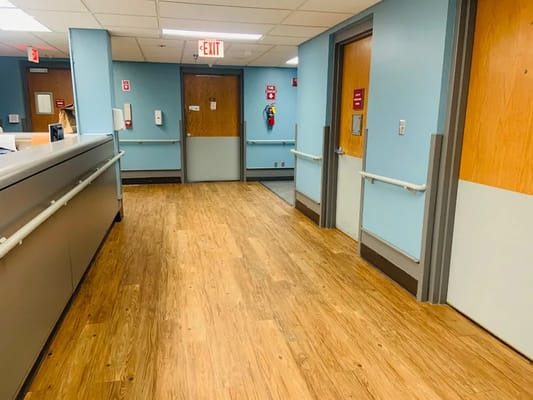 Interior hallway with wooden flooring and blue walls