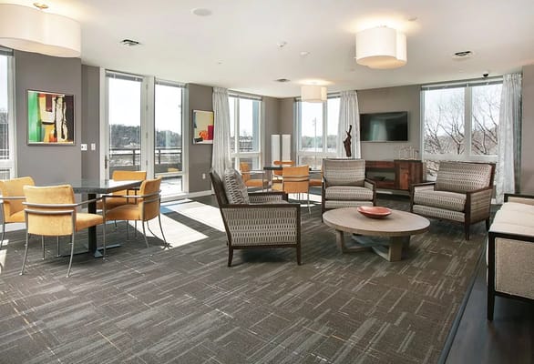 Bright common area with comfortable seating and art