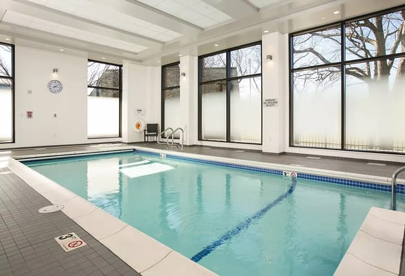 Indoor swimming pool area with large windows