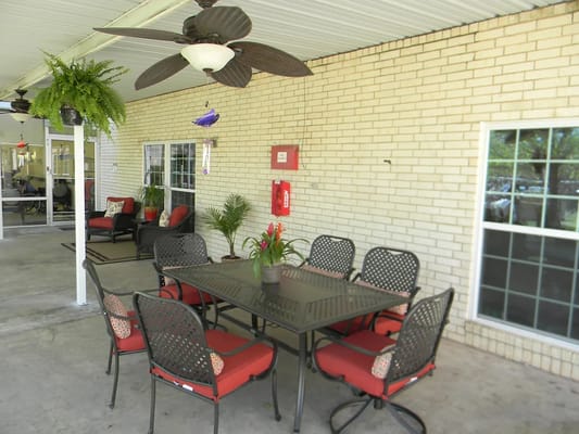 Covered outdoor patio with seating and plants