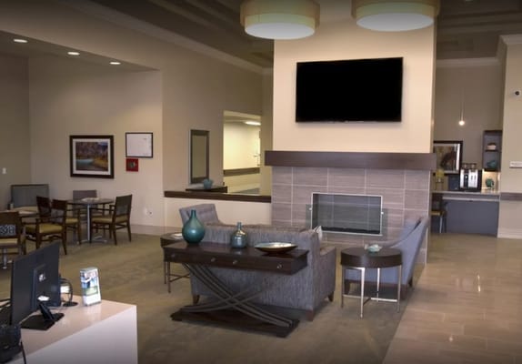Cozy lobby area with seating and a modern fireplace