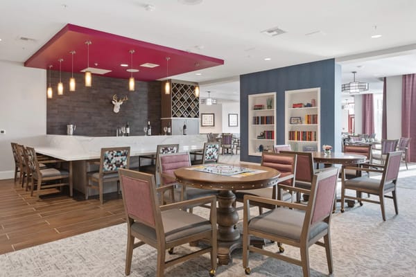 Common area with tables in a senior living facility