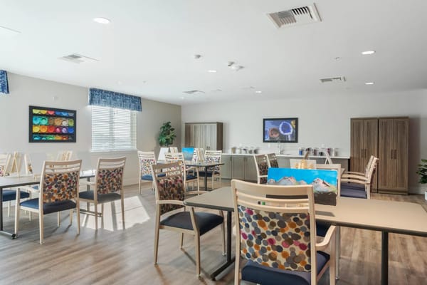 Bright common area with tables and chairs set up